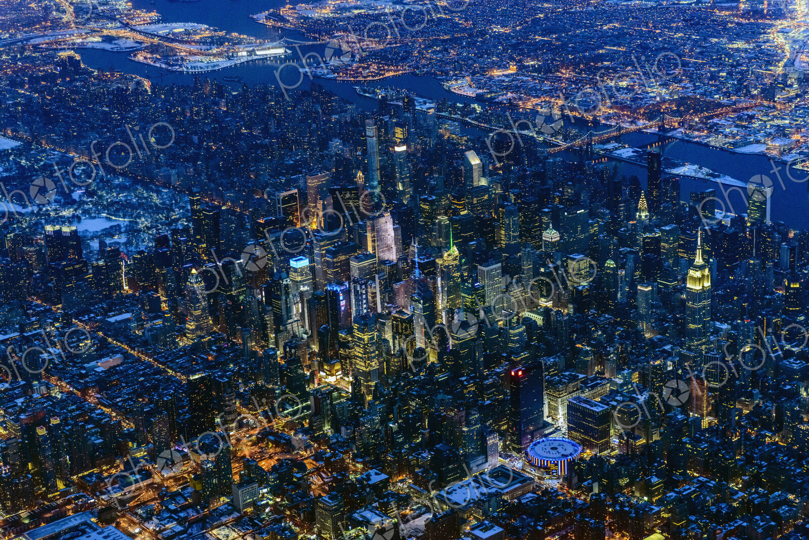 Aerial view of Manhattan cityscape and river at night, New York, United States