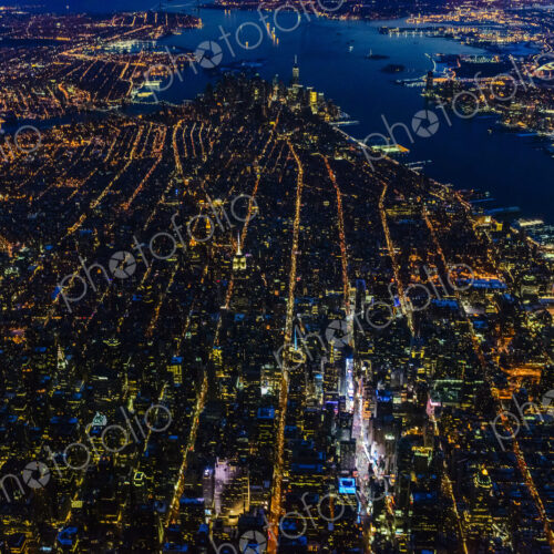 Aerial view of Manhattan cityscape and river at night, New York, United States Aerial view of Manhattan cityscape and river at night, New York, United States