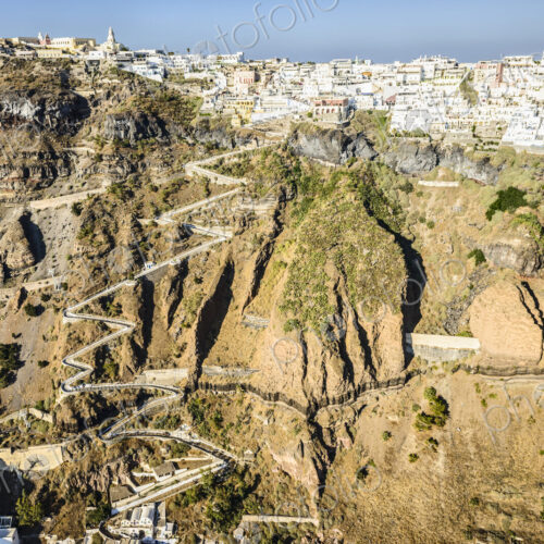 Aerial view of a town at the top of a sheer cliff on the island of Egeo and the… Aerial view of a town at the top of a sheer cliff on the island of Egeo and the…