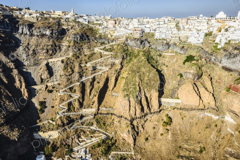 Aerial view of a town at the top of a sheer cliff on the island of Egeo and the…