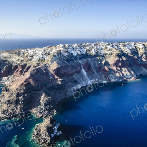 Aerial view of an island in the deep blue seas of the Aegean sea, rock formations,…