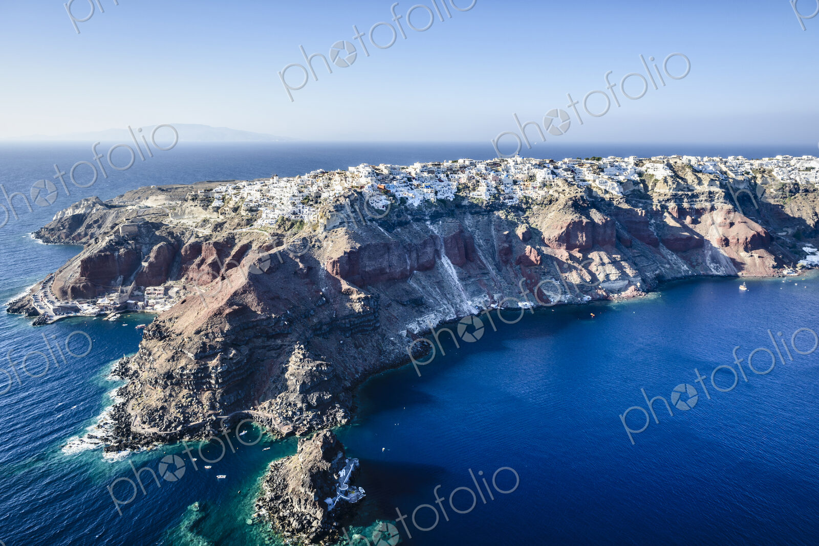 Aerial view of an island in the deep blue seas of the Aegean sea, rock formations,…