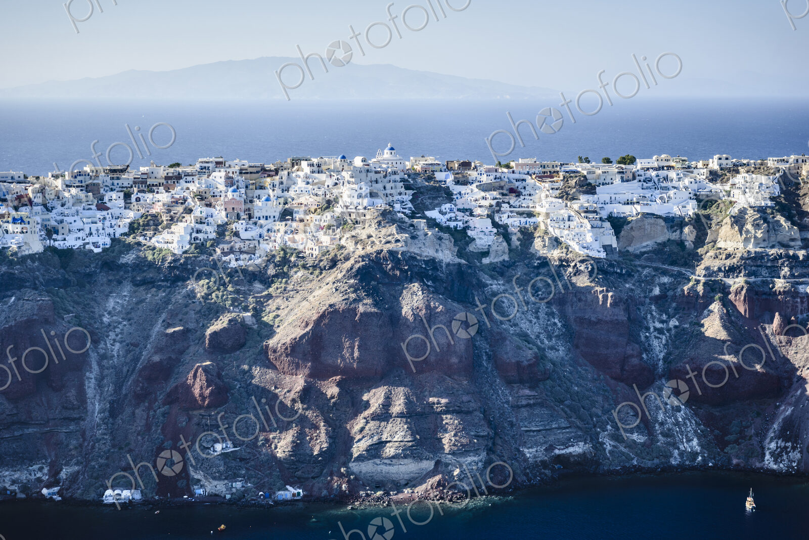 Aerial view of an island in the deep blue seas of the Aegean sea, rock formations,…