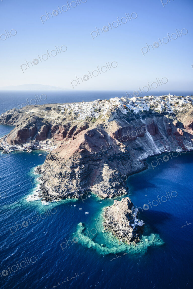 Aerial view of city built on rocky coastline, Oia, Egeo, Greece