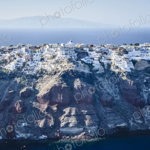 Aerial view of city built on rocky coastline, Oia, Egeo, Greece Aerial view of city built on rocky coastline, Oia, Egeo, Greece