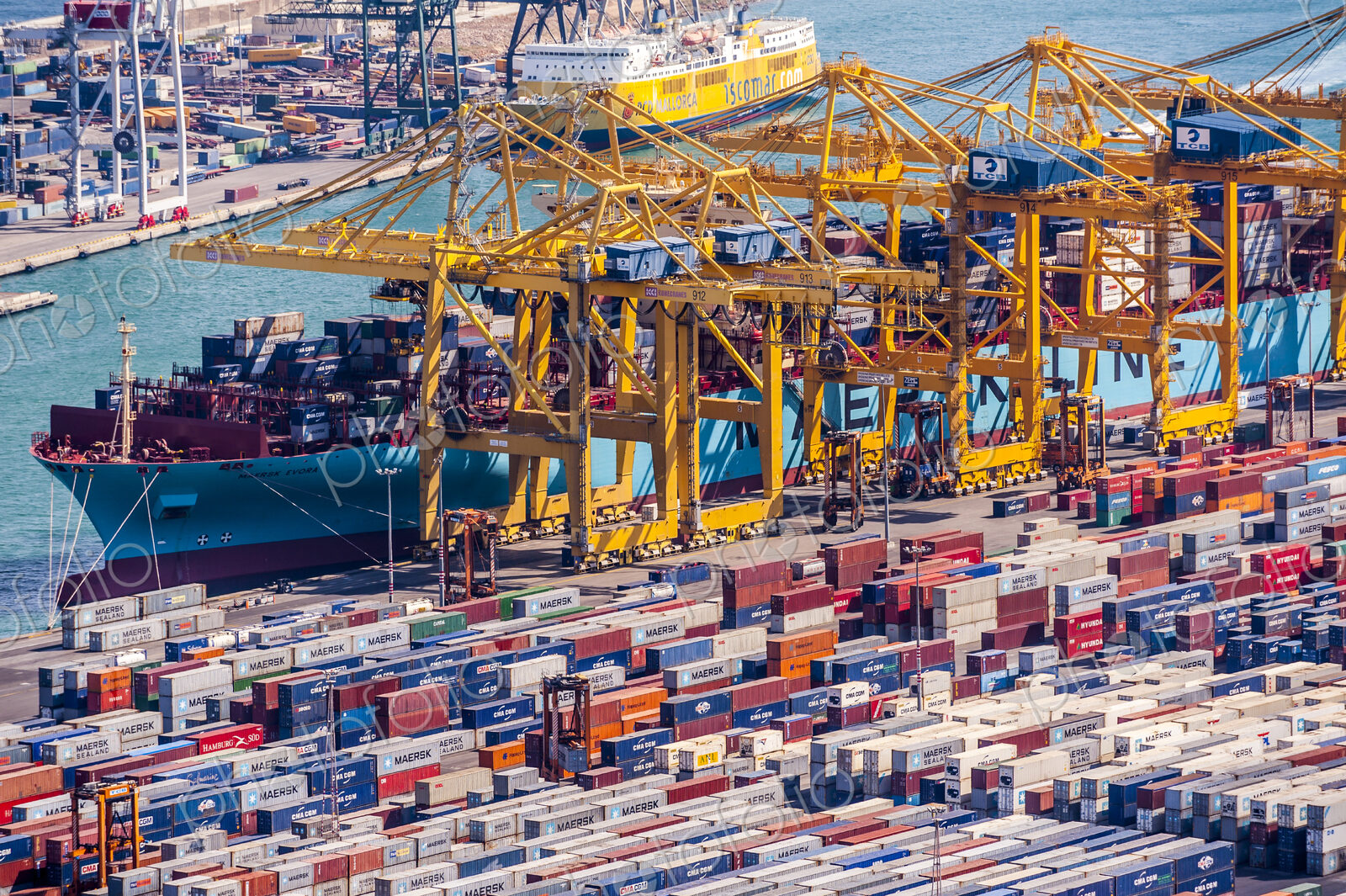 Aerial view of cranes and containers in urban shipyard