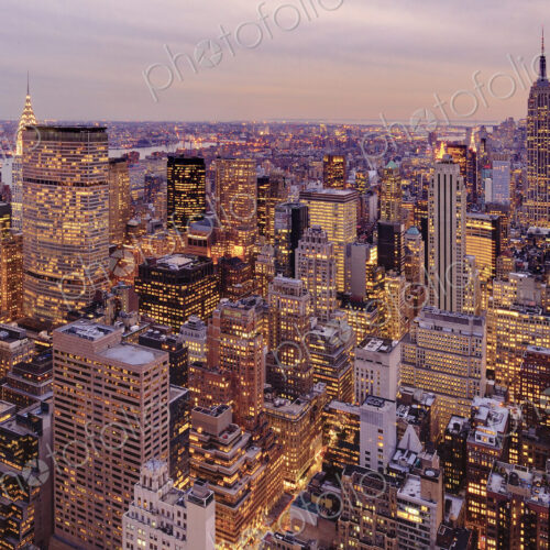 Aerial view of highrise buildings in cityscape at twilight Aerial view of highrise buildings in cityscape at twilight