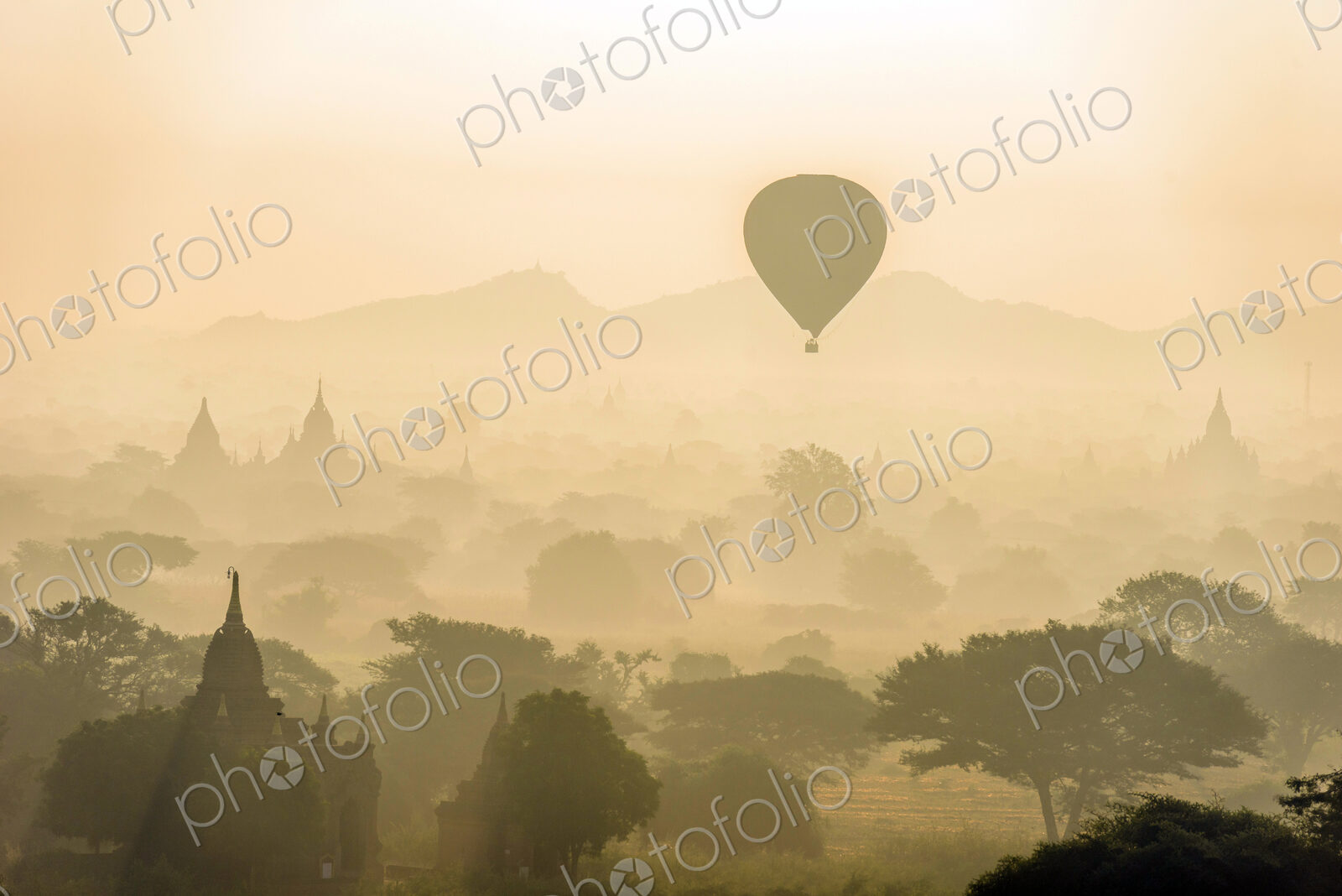 Aerial view of hot air balloons flying over towers