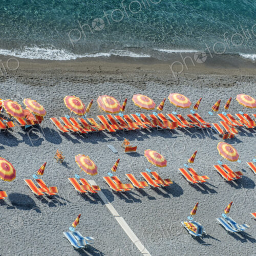 Aerial view of lawn chairs and umbrellas on beach