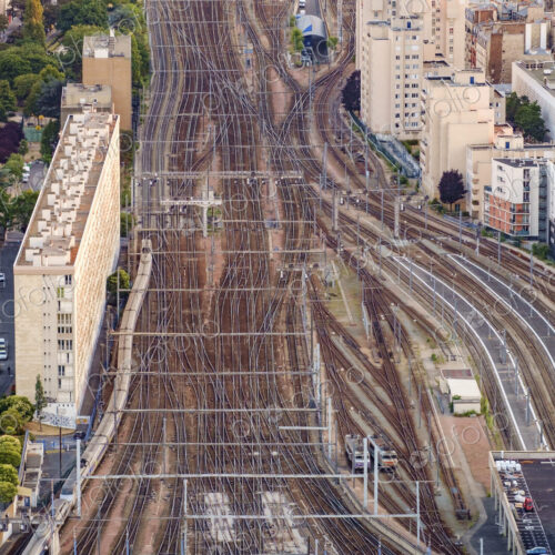 Aerial view of multiple train tracks running into Paris.