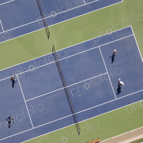 Aerial view of tennis court and people playing tennis. Aerial view of tennis court and people playing tennis.