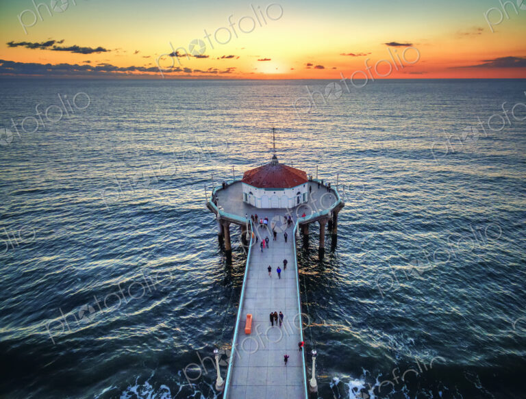 Aerial view of the Manhattan Beach Pier at sunset.