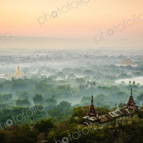 Aerial view of towers in misty landscape