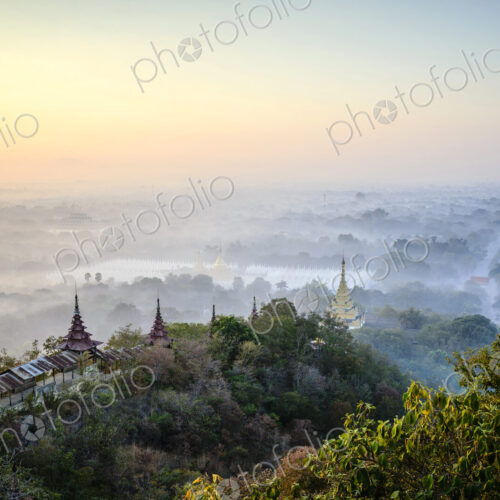 Aerial view of towers in misty landscape
