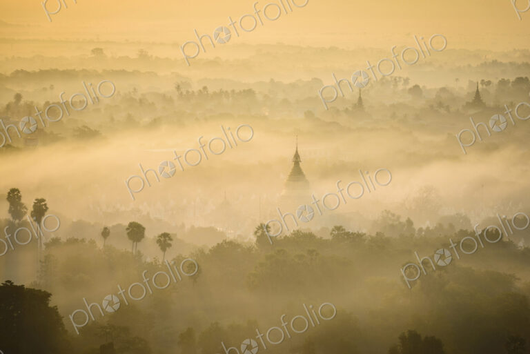 Aerial view of towers in misty landscape
