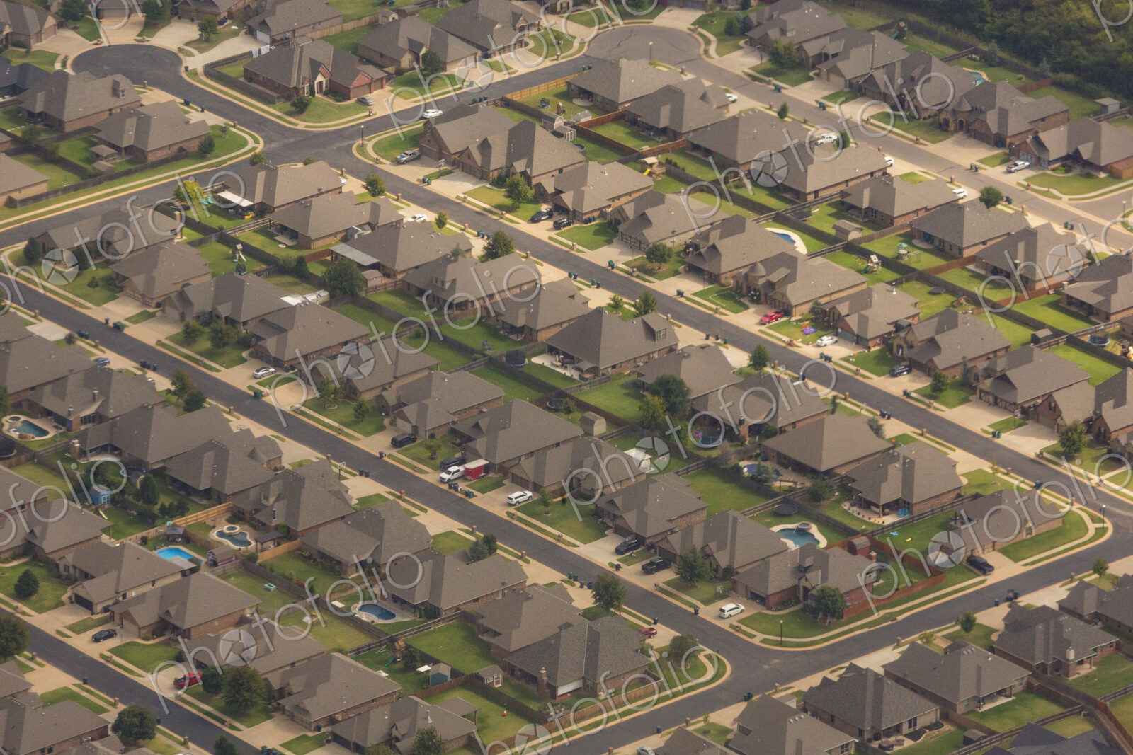Aerial view over a suburb of residential buildings, houses build in a neat grid…