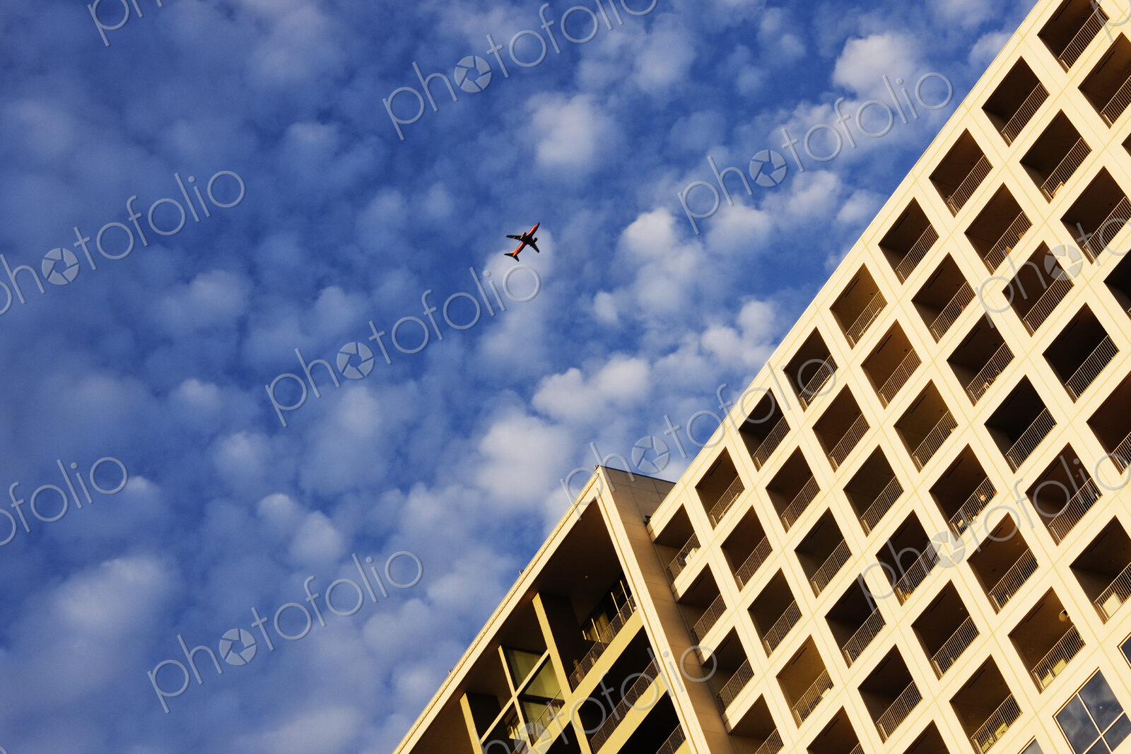 Airplane Flying Over Building