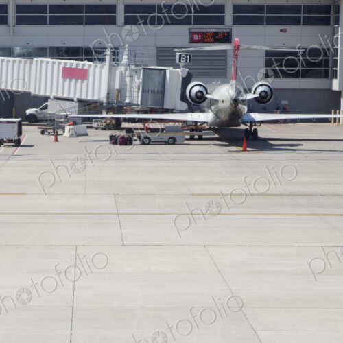 Airplane with air bridge at airport.