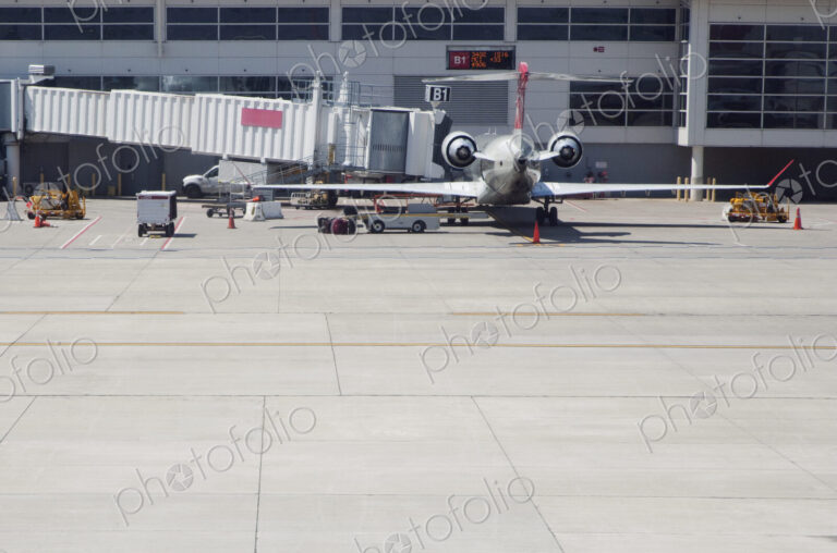 Airplane with air bridge at airport.