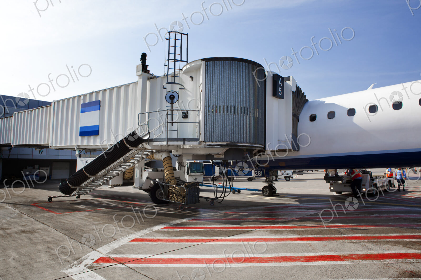 Airport buildings, airbridge for passengers, and aircraft on the ground