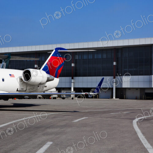 Airport buildings and a passenger aircraft on the ground