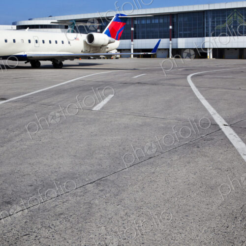 Airport buildings and a passenger aircraft on the ground Airport buildings and a passenger aircraft on the ground