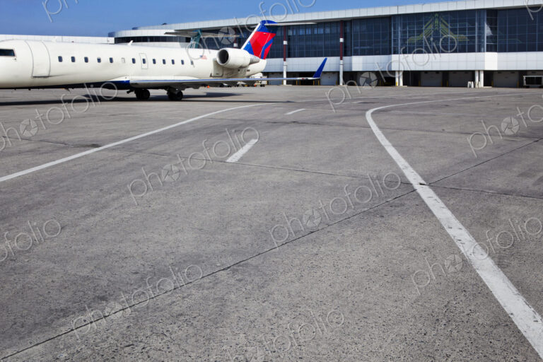 Airport buildings and a passenger aircraft on the ground