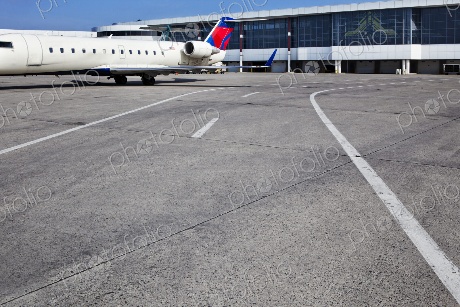 Airport buildings and a passenger aircraft on the ground