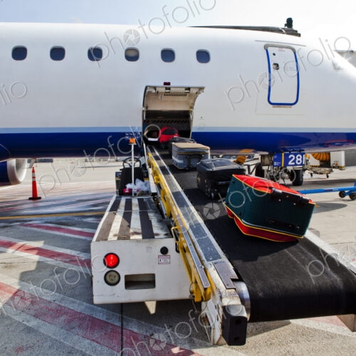 Airport, passenger aircraft on the ground, baggage being loaded