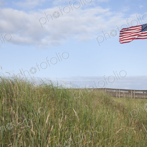 American flag flying in grassland.