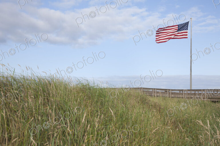 American flag flying in grassland.