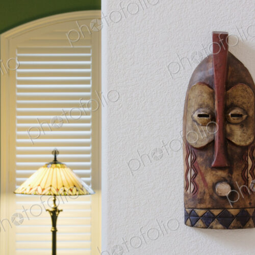 An African traditional mask hanging on a wall An African traditional mask hanging on a wall