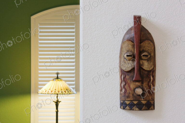 An African traditional mask hanging on a wall