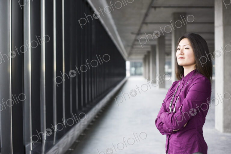 An Asian female business owner in a new raw business space.