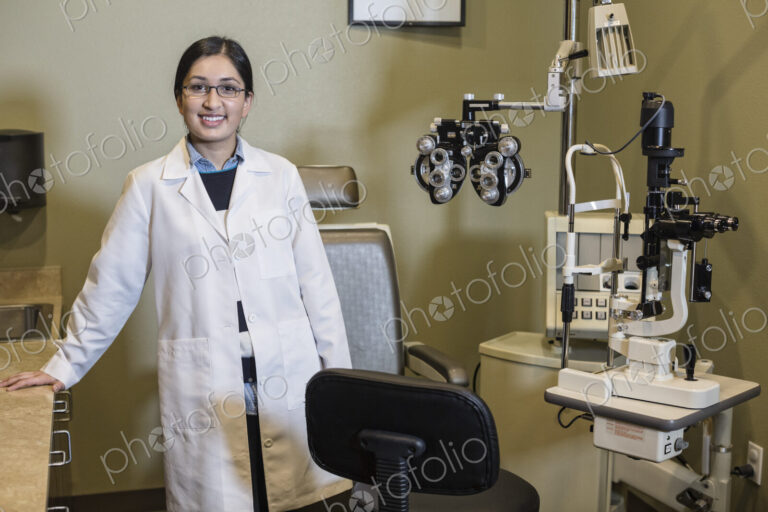 An Asian woman ophthalmologist in her office examination room.