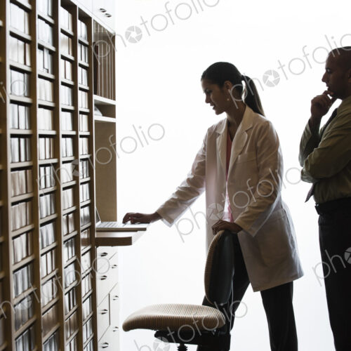 An Hispanic female dentist and a Middle Eastern dentist looking at a computer in their… An Hispanic female dentist and a Middle Eastern dentist looking at a computer in their…