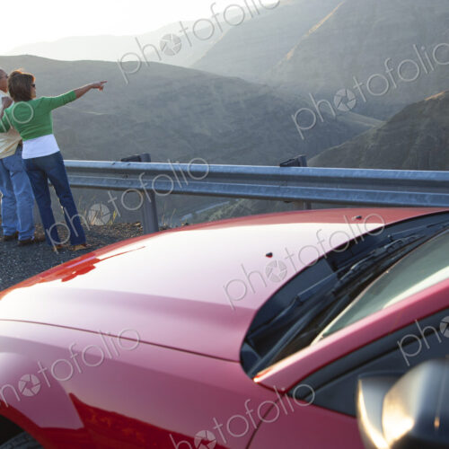 An Hispanic senior couple enjoying the scenery from a rest stop on a highway