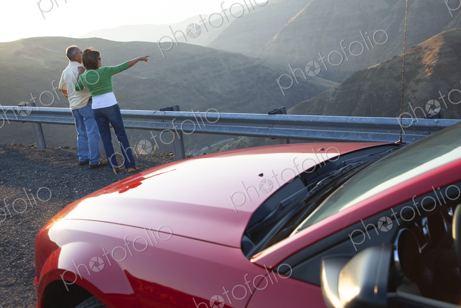 An Hispanic senior couple enjoying the scenery from a rest stop on a highway