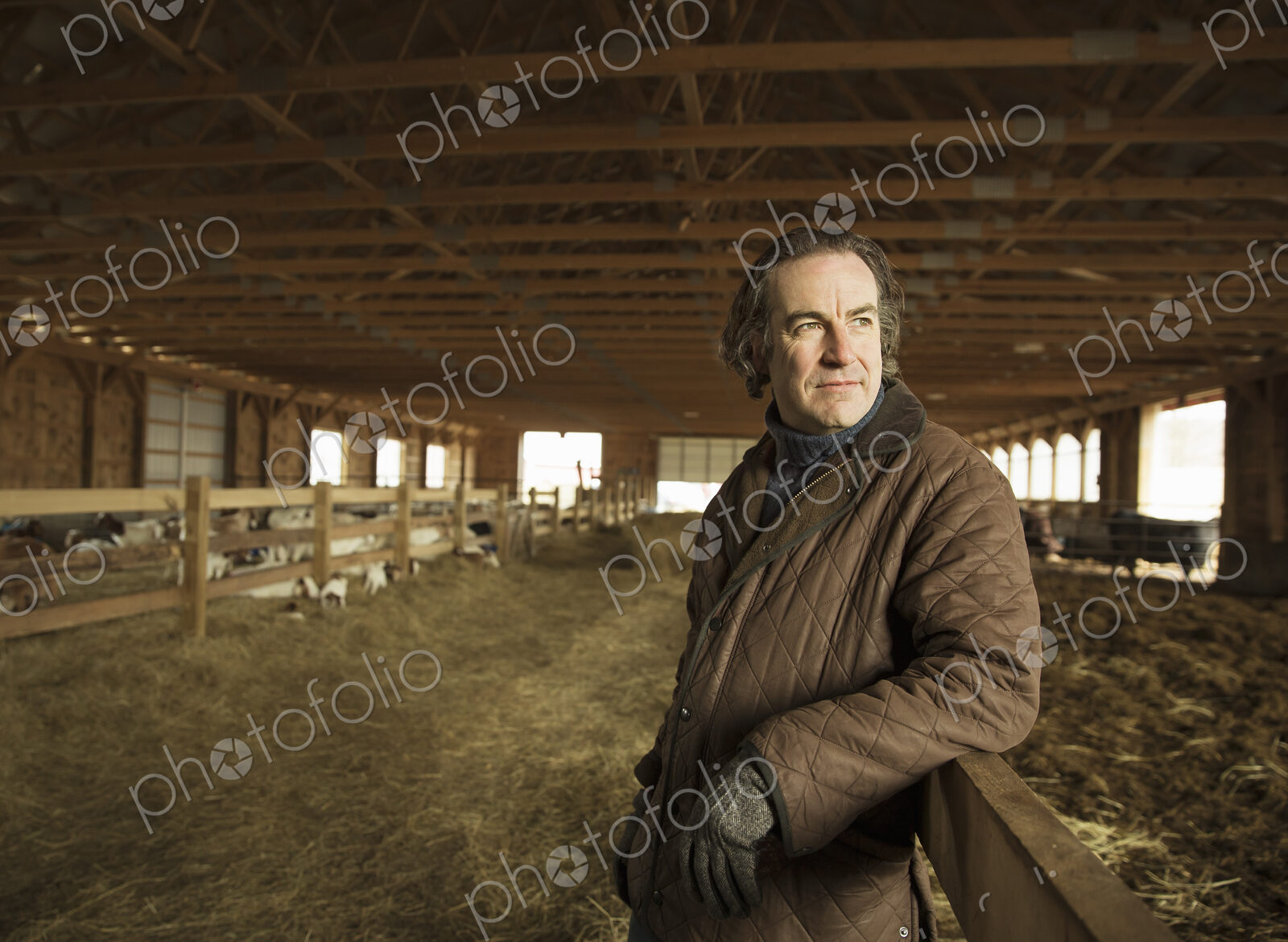 An Organic Farm in Winter in Cold Spring, New York State. A farmer in a livestock barn…