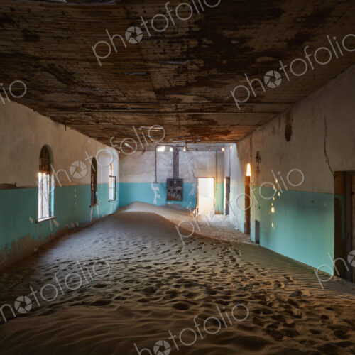 An abandoned building with boarded up windows, and shafts of sunlight lighting up the… An abandoned building with boarded up windows, and shafts of sunlight lighting up the…