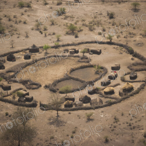 An aerial view of a small rural village settlement, with traditional buildings and… An aerial view of a small rural village settlement, with traditional buildings and…