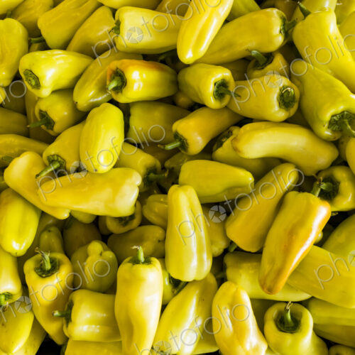 An agricultural market stall, close up of yellow chili peppers.
