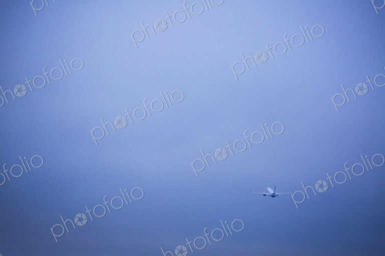 An aircraft taking off in a clear blue sky.