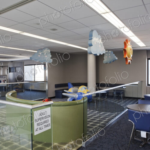 An airport departure lounge children's play area with signs. Tables and chairs. An airport departure lounge children's play area with signs. Tables and chairs.