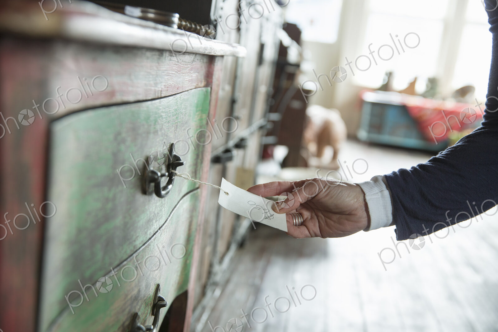 An antique store in a small town, with objects and furniture from the past. A woman’s…