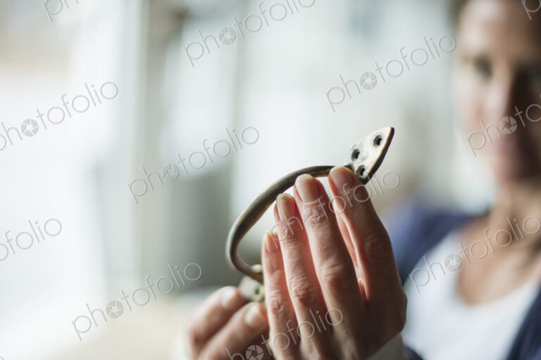 An antique store in a small town, with objects and furniture from the past. A woman…