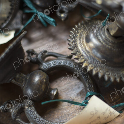 An antique store with a display of objects and furniture from the past. Chased metal… An antique store with a display of objects and furniture from the past. Chased metal…