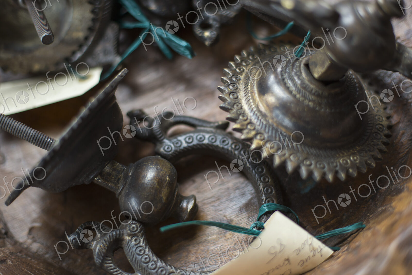 An antique store with a display of objects and furniture from the past. Chased metal…
