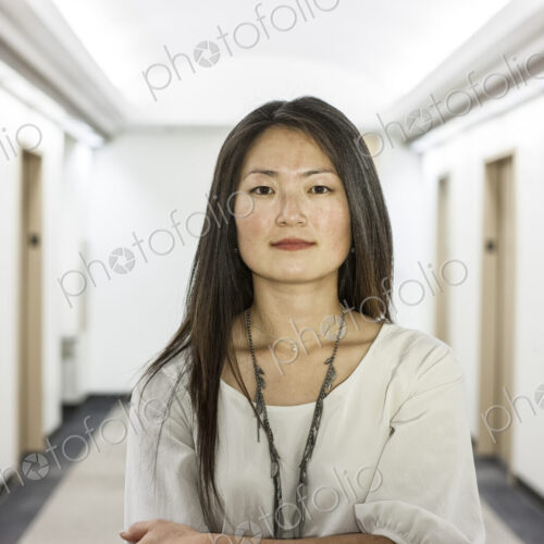 An asian businesswoman stanidng alone in her office space. An asian businesswoman stanidng alone in her office space.