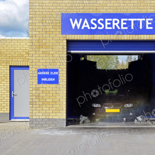 An automated car wash in operation with open door. An automated car wash in operation with open door.